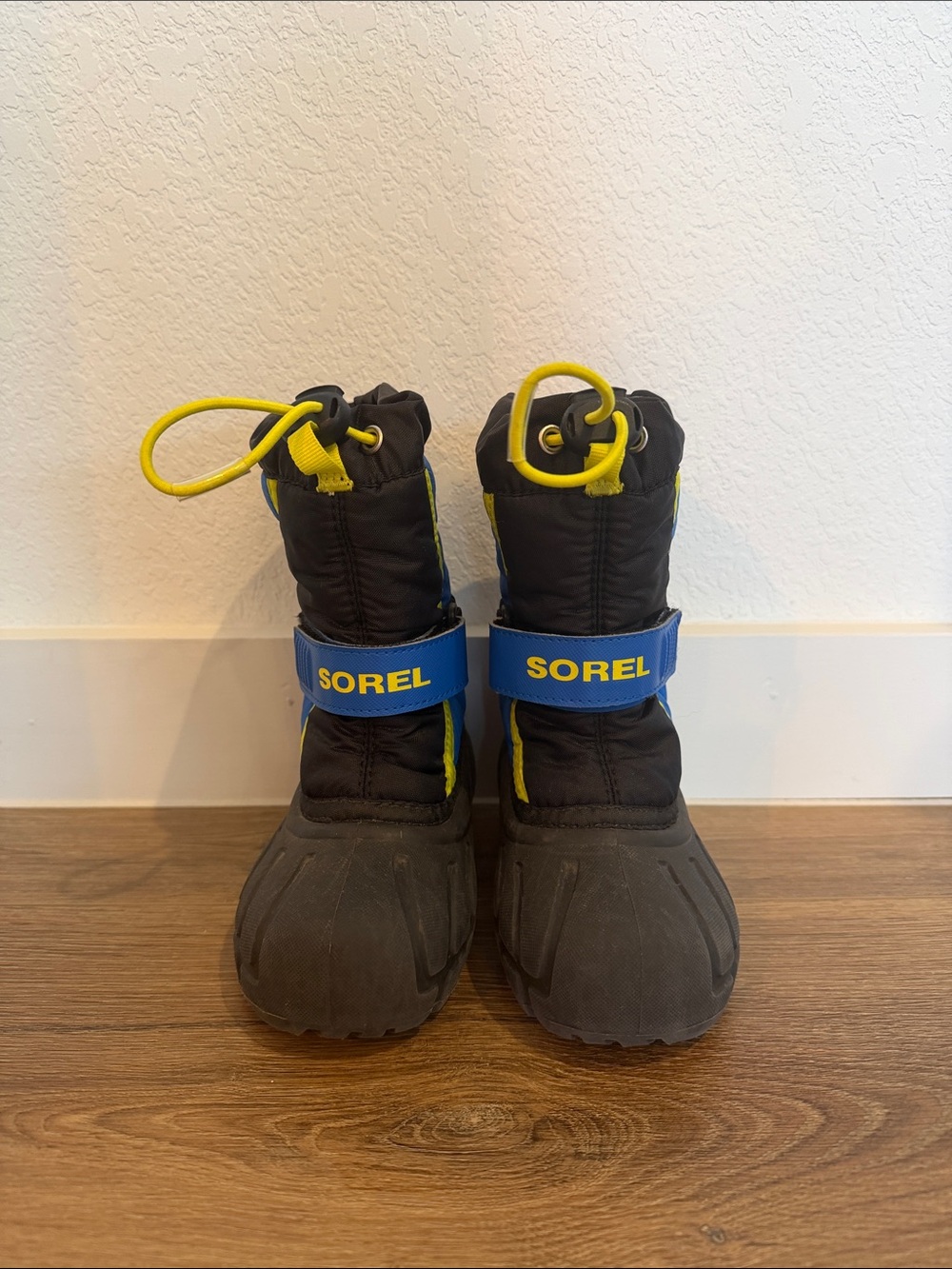 Sorel Black Kids Snow Boots with Blue Strap and Yellow Accents